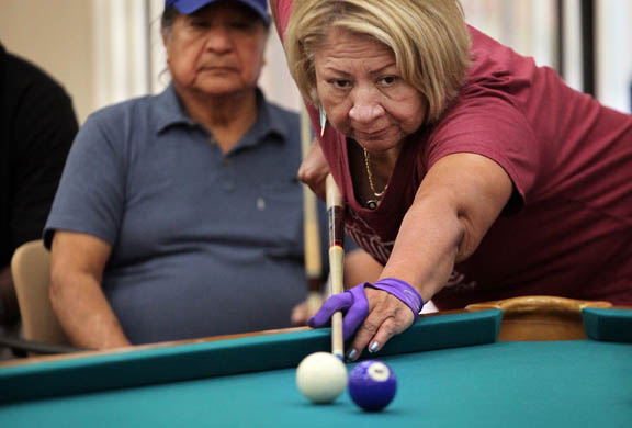 Louise Osceola concentrates on pocketing a ball Sept. 11 during a senior pool tourney in Big Cypress.