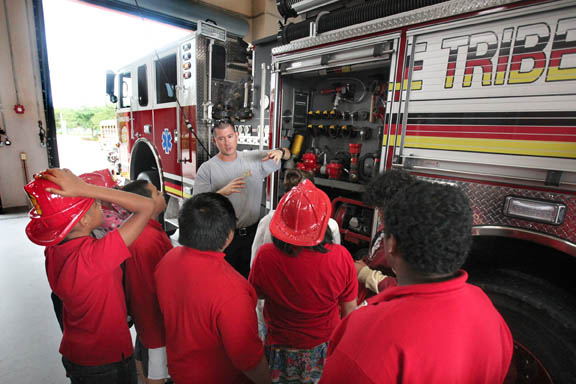 Firefighter-driver/engineer Karlos Suarez gives Ahfachkee School students an up-close look at firefighting tools Oct. 5 during a morning of fire prevention education at Fire Station 2 in Big Cypress.