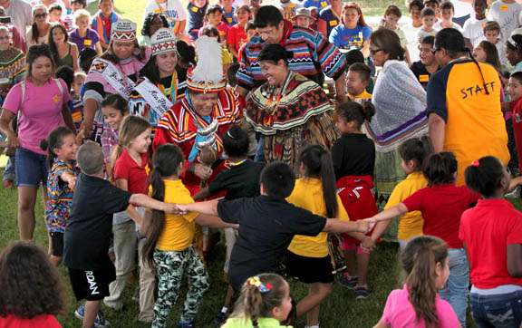 Tribal medicine man Bobby Henry leads a serpentine line of students, teachers and Seminole Tribe members in a friendship stomp dance Nov. 6 at the Ah-Tah-Thi-Ki- Museum’s 18th annual  American Indian Arts Celebration.