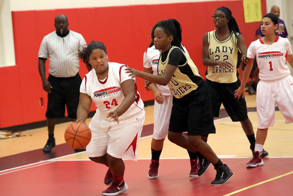 Pemayetv Emahakv Charter School center Tava Harris controls the ball against Moore Haven Middle School’s Zorian Tullock during PECS’ 34-11 win in Brighton. The sixth-grader excelled on the boards at both ends and scored two points.