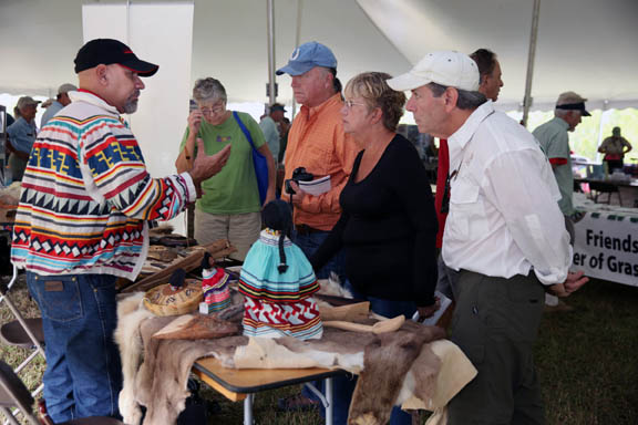 Ah-Tah-Thi-Ki Museum community outreach specialist Reinaldo Becerra explains the role of the Seminole Tribe to festival attendees Dec. 5 at the Big Cypress Swamp Heritage Festival in Ochopee. 