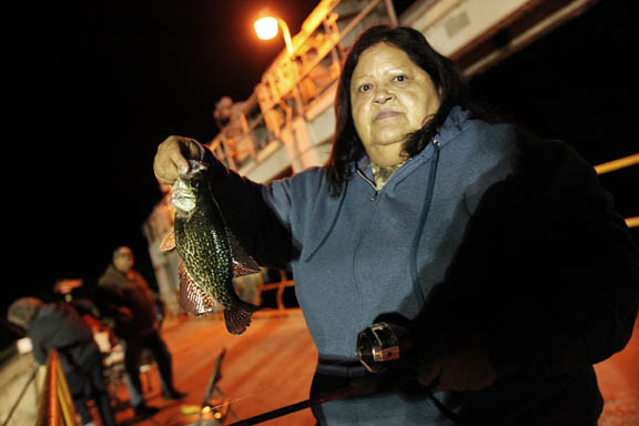 Debbie Carter, whose mother, Leah Minnick, established senior fishing nights out hosted by the Brighton Elder Services Department, shows her fresh-caught black crappie.