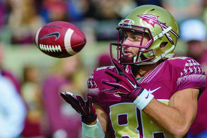 The Seminole Tribe’s Justin Motlow focuses on the ball during Florida State’s 2015 season. Motlow saw his first game action this season for FSU, which finished with a 10-3 record.   (Photo courtesy of Perrone Ford, Florida State Sports Information) 