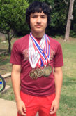 Julius Aquino wears some of the medals he’s captured in track and field.