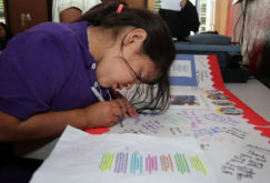 Mary Jane Martinez, 7, adds her thanks to the poster for SPD.