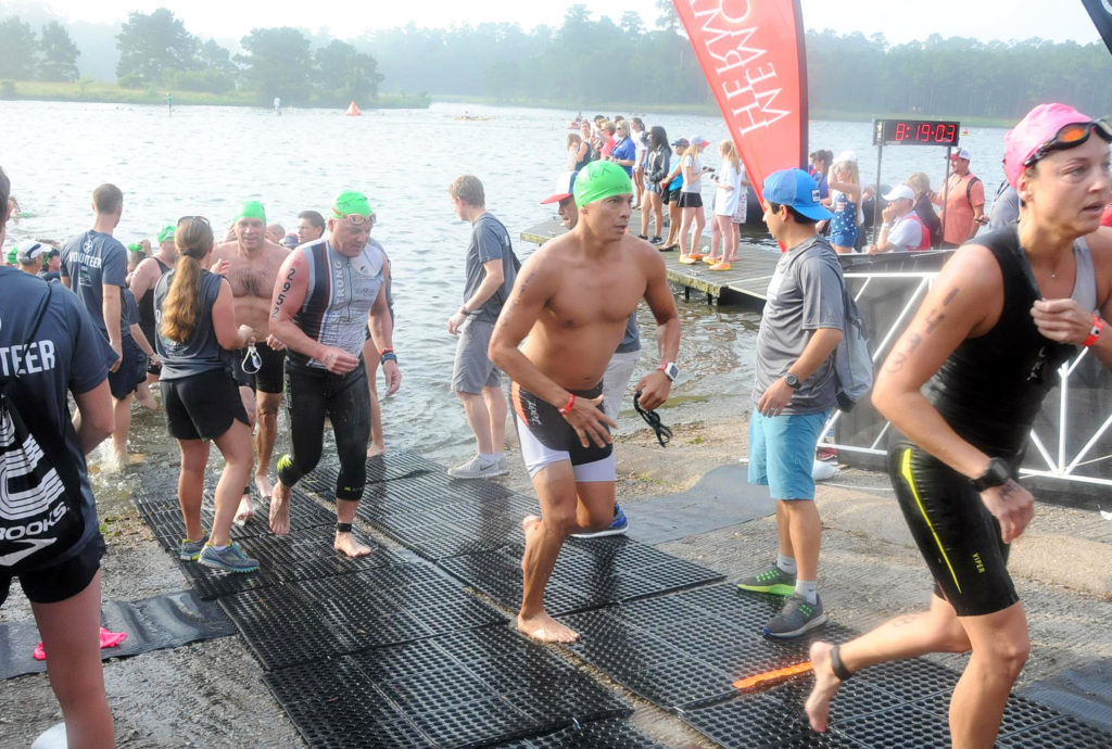 Pete Osceola III, center, emerges from the water while competing in the Memorial Hermann North American Championship Ironman Texas on May 14 in The Woodlands, Texas. (Photo by FinisherPix.com)