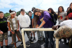 PECS student Karey Gopher, 12, attempts to stop a leak the same way Public Works Department employees do with underground leaks during a tour of the facility May 19.