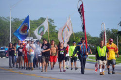 Tribal members join participants in the Longest Walk 5 as they walk through Big Cypress Reservation June 5. The purpose of the 3,600-mile coast-to-coast walk is to end drug abuse and domestic violence in Indian Country. 