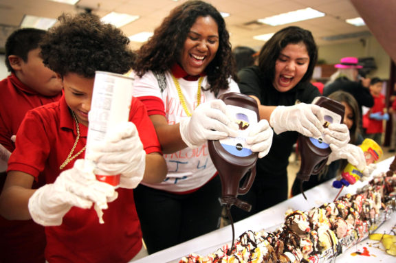 As part of Red Ribbon week, Ahfachkee School students use teamwork to create Indian Country’s largest banana split Oct. 20. The sundae with all the fixings, including cherries on top, took less than 6 minutes to make. It took much longer for students and staff to consume. (Beverly Bidney photo)