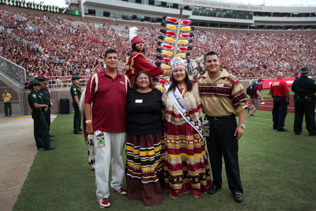 The Doney family poses with Osceola and Renegade on the sidelines of FSU’s Doak Campbell Stadium after halftime Oct. 15. From left are Ken, Marilyn, Miss Florida Seminole Kirsten and Kyle Doney