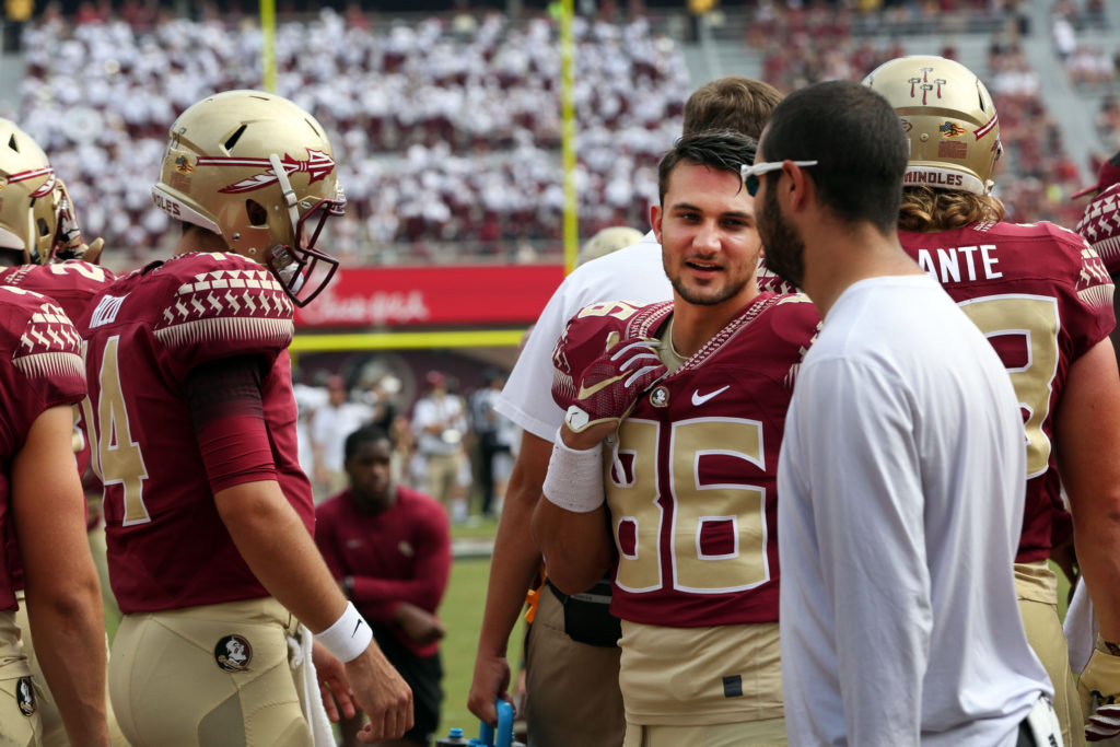 Seminole Tribal citizen and FSU Seminole wide receiver Justin Motlow (86) consults with his teammates on the sidelines before the homecoming game against Wake Forest Oct. 15.