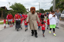 Crime-fighting canine McGruff walks with Hollywood Preschool students during a Red Ribbon event Oct. 24. (Stephanie Rodriguez photo)