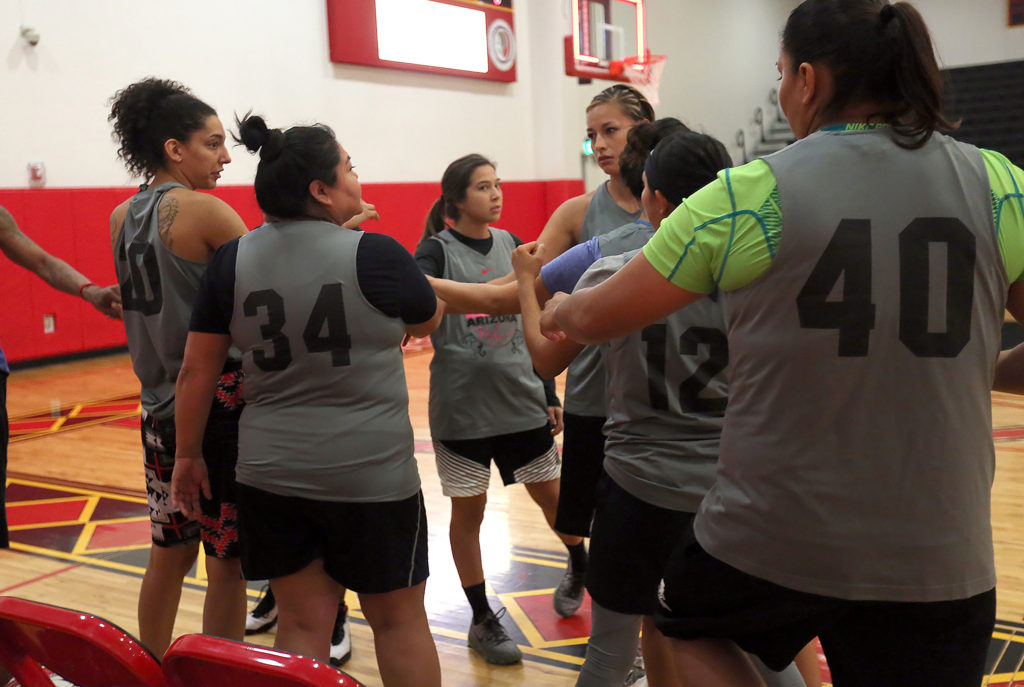 Jude Schimmel, center, joins her teammates on the X-Factor team in a huddle for a first round game in the annual Randall Huggins Memorial Big Ballers Tournament on Dec. 9 at the Howard Tiger Recreation Center in Hollywood. (Kevin Johnson photo)