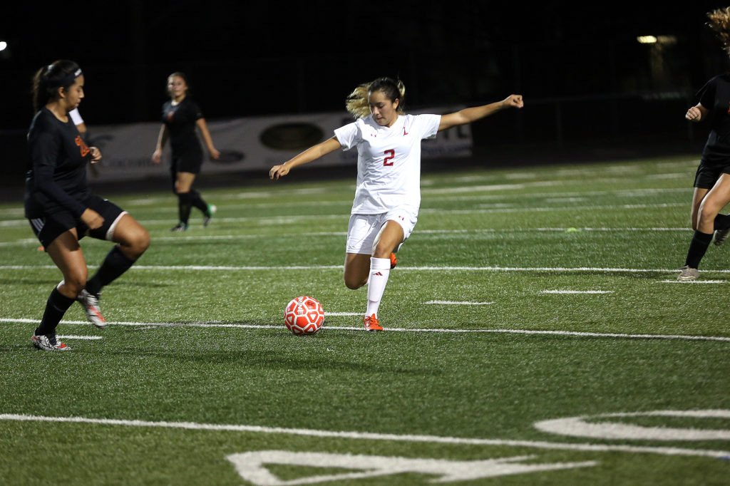 Immokalee High's Jillian Rodriguez belts the ball during a game against Lely. (Kevin Johnson photo)