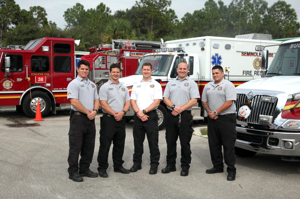 Immokalee Fire Station’s engine and two rescues make an appropriate backdrop for this shift of firefighters Dec. 8. From left are driver Eduardo Costa, Lt. Mark LaMadeleine, battalion commander Jason Allis, Lt. Frank Rodriguez and firefighter Nicholas Garcia. (Beverly Bidney photo)
