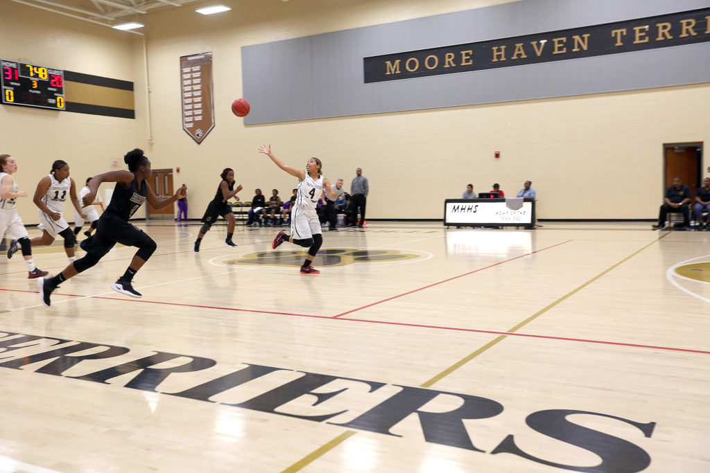 Moore Haven senior guard Sydnee Cypress gets a fastbreak pass on her way for a basketball against Okeechobee High School on Nov. 30 at Moore Haven High School. (Kevin Johnson photo) 