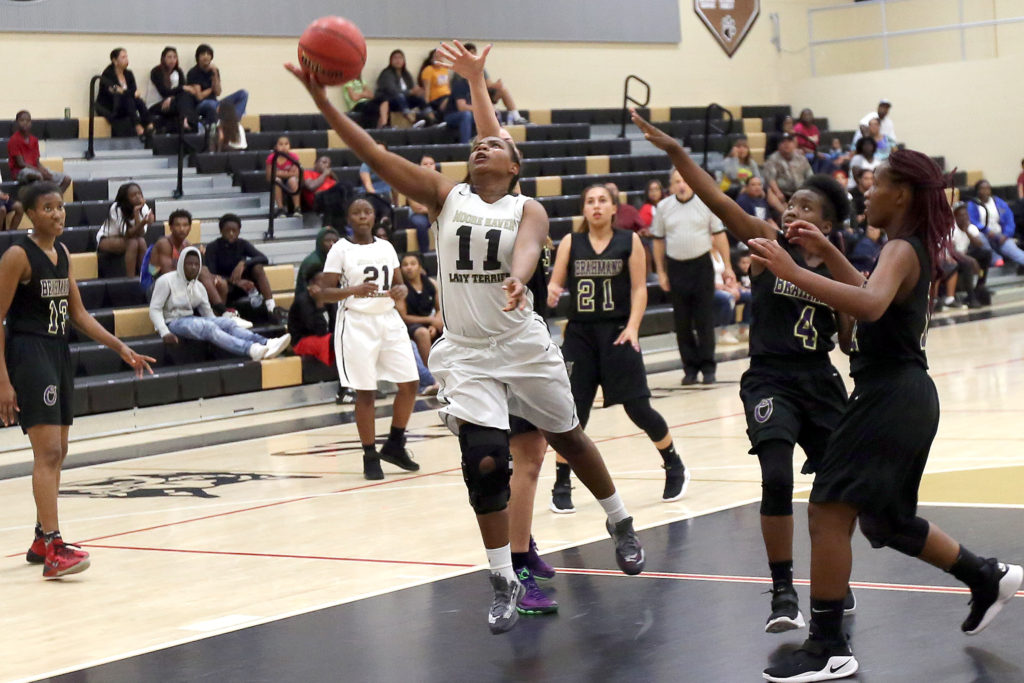 Moore Haven's Alicia Fudge splits Okeechobee defenders for a basket Nov. 30. (Kevin Johnson photo)