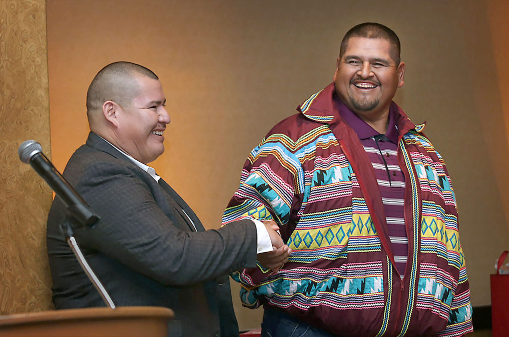 Neil Baxley, currently the slots director at Seminole Casino Coconut Creek, is congratulated by Big Cypress Councilman Cicero Osceola during Baxley’s Tribal Career Development graduation ceremony Dec. 15 at Seminole Hard Rock Hotel and Casino Hollywood. (Eileen Soler photo)