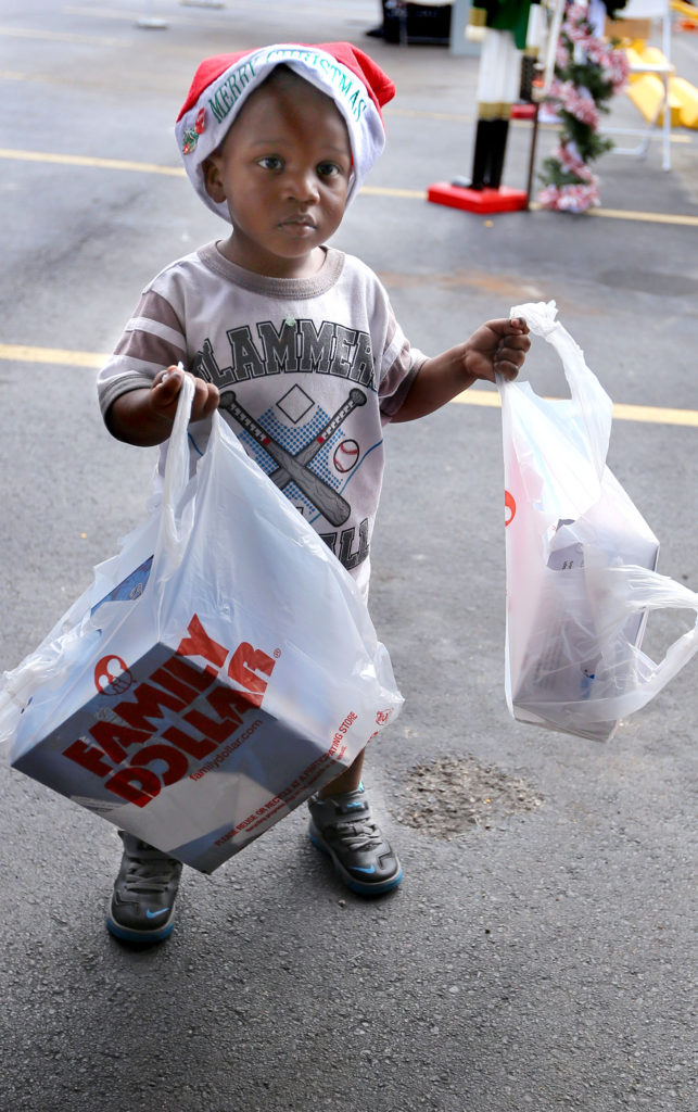 A youngster brings bags of toys to donate to the Seminole Tribe's toy drive next to the Seminole Classic Casino in Hollywood. (Eileen Soler photo)