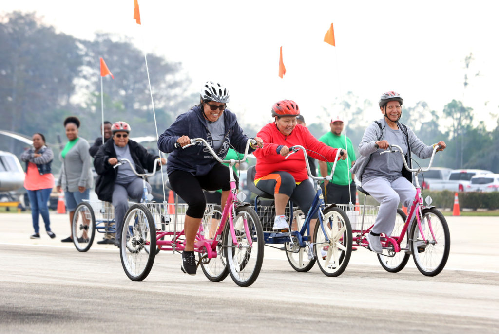 Seniors rev up their trikes and work their legs for the drag race at the 12th annual Trike Fest in Big Cypress. (Beverly Bidney photo)
