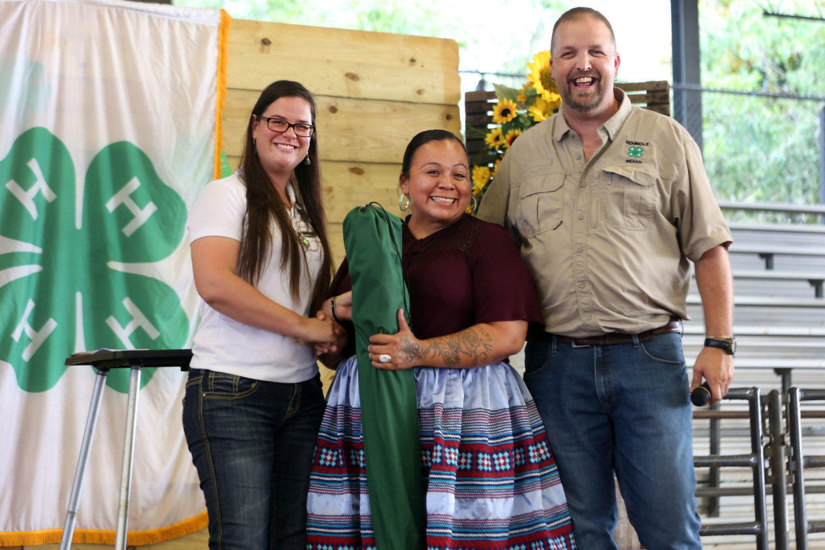 Tammy Billie, surrounded by Kimberly Clement, 4-H program assistant, and Aaron Stam, Florida Cooperative Extension agent, is honored for her work in 4-H at the Seminole Indian 4-H awards banquet on June 4. (Beverly Bidney photo)
