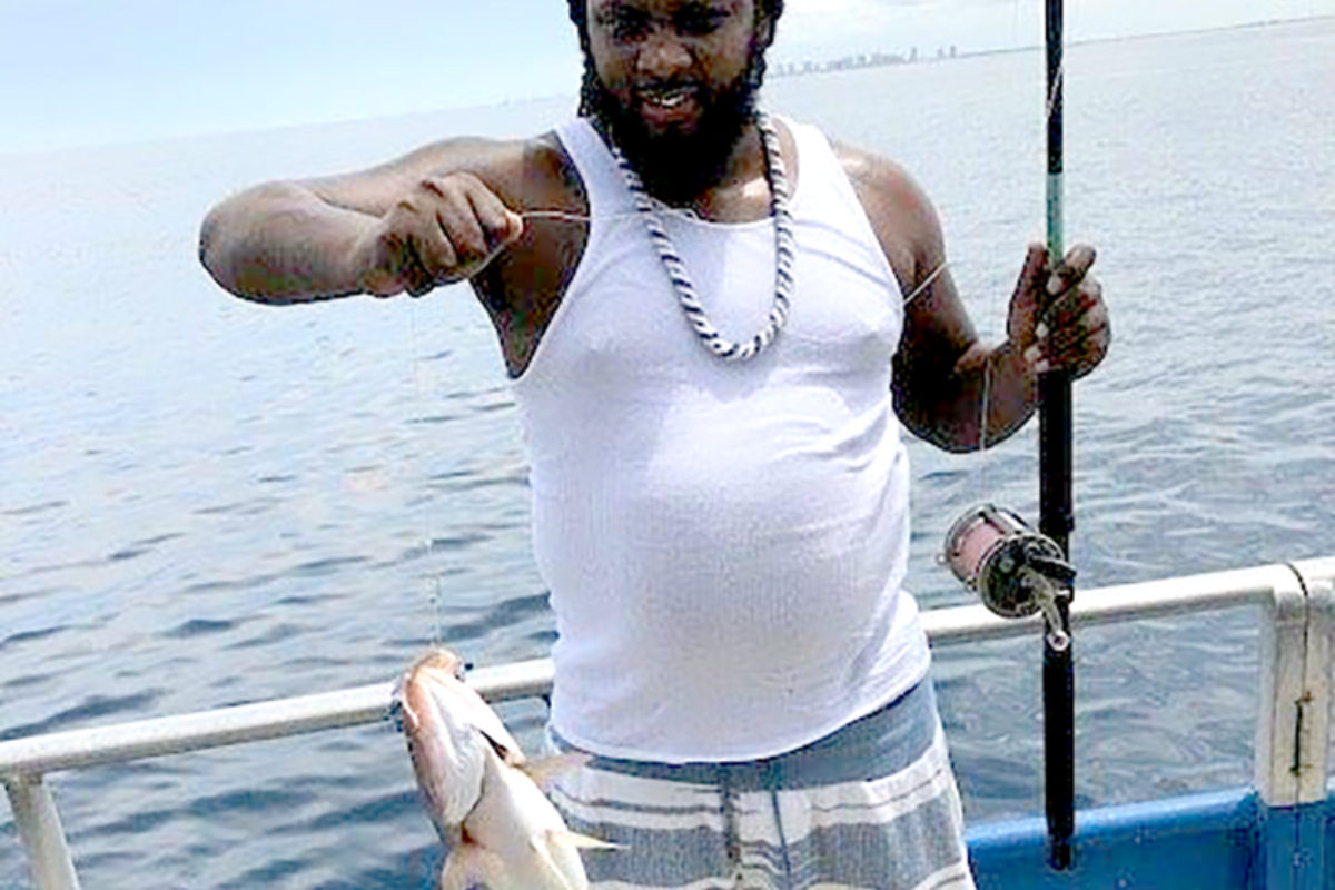 Travelis Timothy reels in a fish during the Fort Pierce Father’s Day chartered fishing trip.  (Courtesy photo)