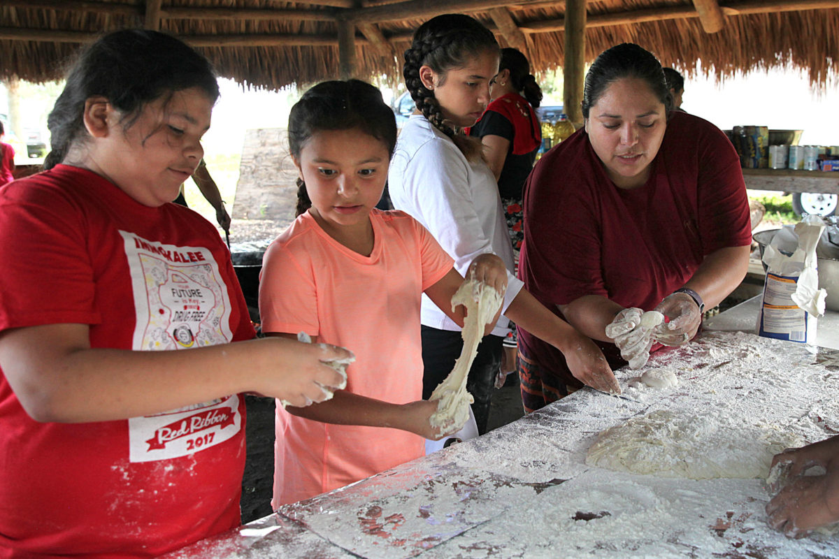 Learning to make fry bread dough can be an adventure but with help from Juanita Martinez, these girls figure it out. (Beverly Bidney photo)