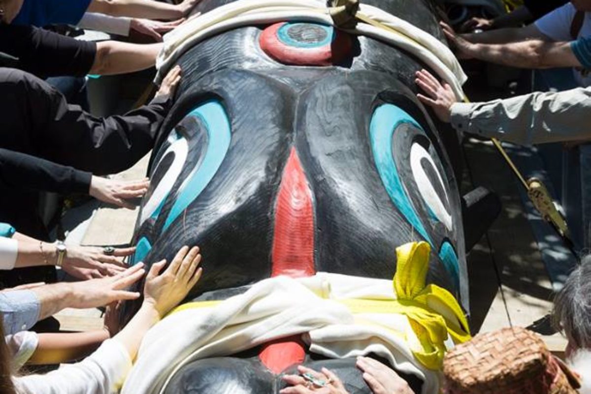 along the trek, supporters lay hands on the totem pole created by Lummi Nation artist Jewell James. (Courtesy Lummi Nation Councilmember Fred Lane)