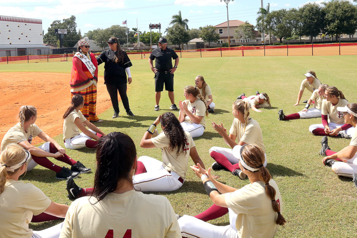 Jr. Miss Florida Seminole Thomlynn Billie speaks to the Florida State softball team after the Seminoles defeated Florida International University in a fall exhibition game Oct. 23, 2016, at Osceola Park on the Hollywood Reservation. (Kevin Johnson photo)