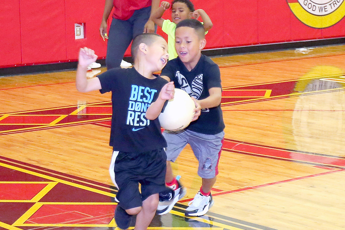Carter Wilcox tags out Lakota Correa during the Hollywood sports camp kickball game. (Kevin Johnson photo)