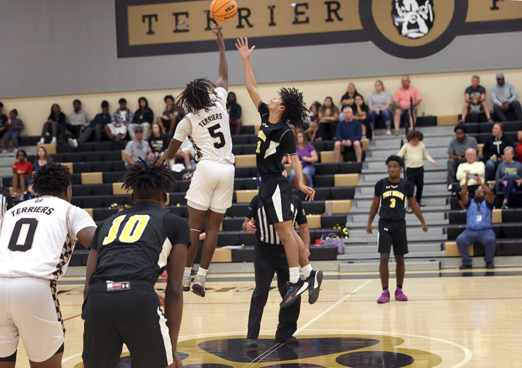 Moore Haven's Aaryn Askew (5) wins the opening tip in the Rural Class District 8 boys basketball championship game against Fort Meade on Feb. 7, 2025. (Photo by Kevin Johnson/The Seminole Tribune)