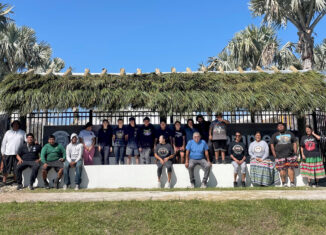 Culture staff, adult helpers and students pose by the new chickee they built in front of the Brighton Cultural Center Complex in March.