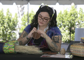 Randelle Osceola works at her basketry demonstration booth.