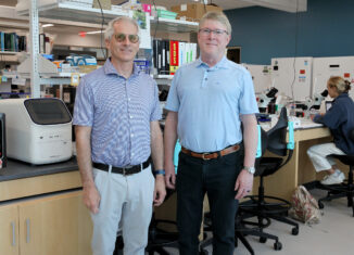 Brian Bovard, left, and Greg Tolley stand in a lab.