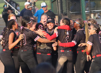 The ECS team celebrates with a group hug and lots of smiles.